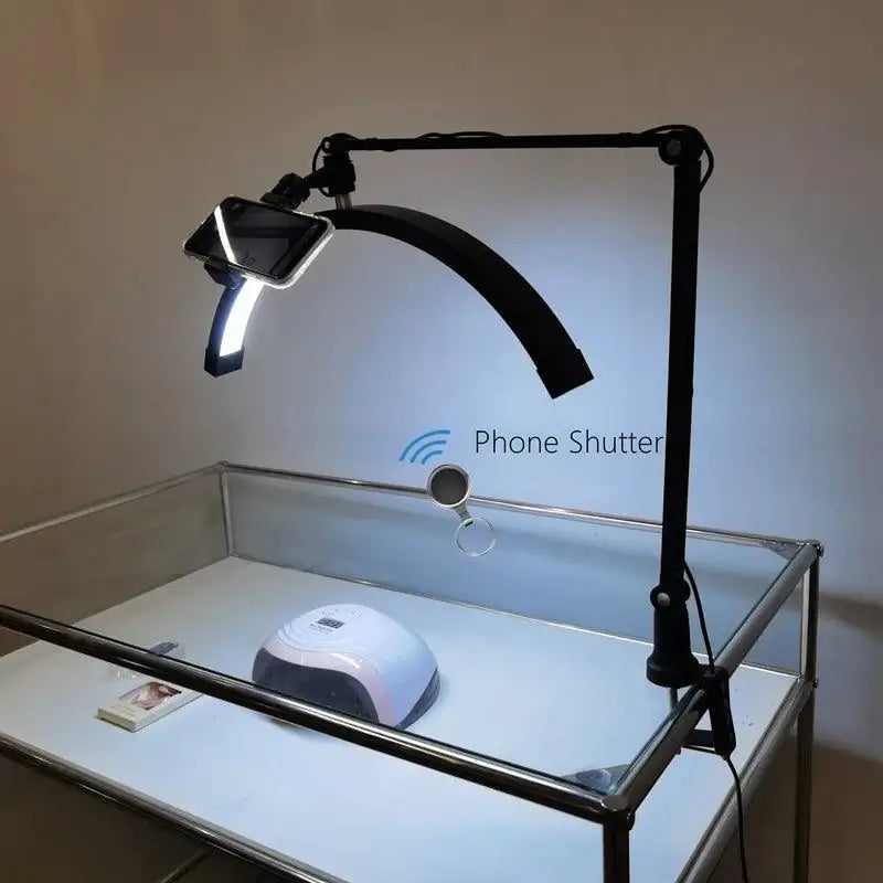 Arch Nail Table Lamp with phone holder, designed for beauty salons and manicure lighting, showcasing fill light setup on work desk.