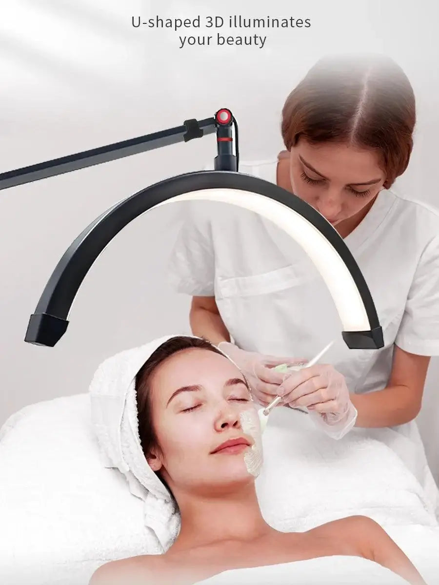 U-shaped 3D ring light illuminating a woman receiving a facial treatment in a beauty salon.